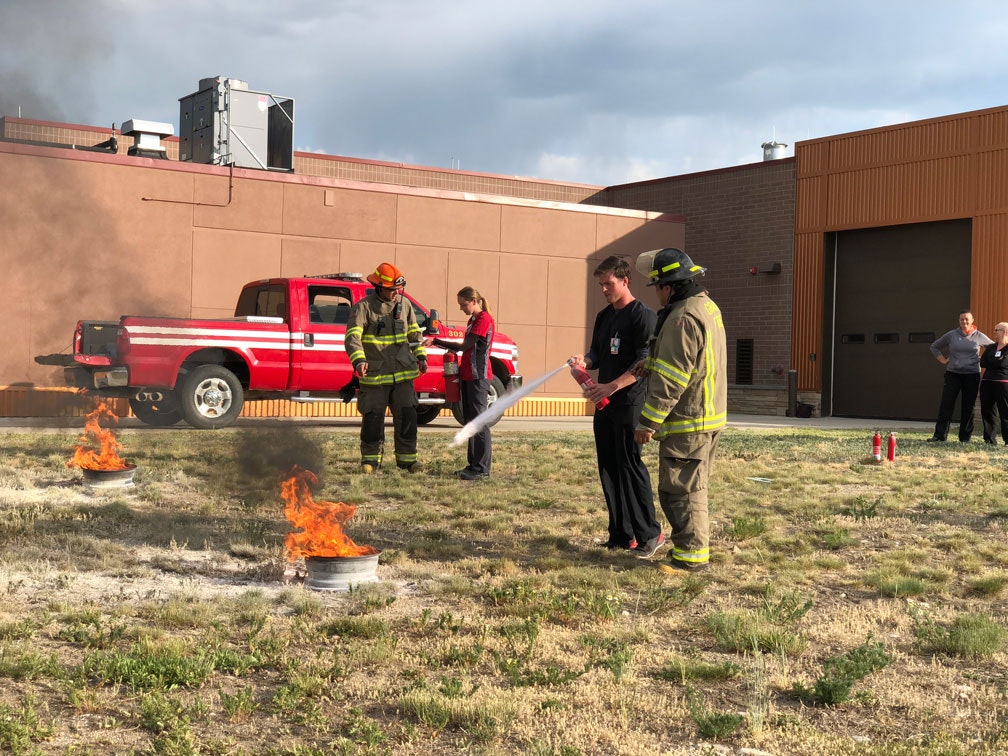 firefighter using a fire extinguisher
