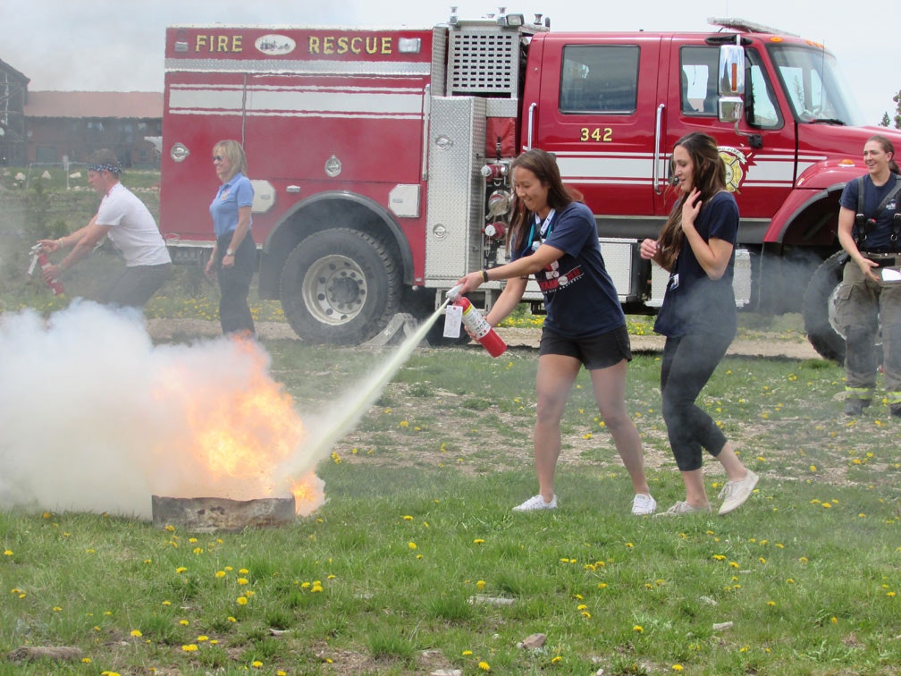 teenagers using a fire extinguisher