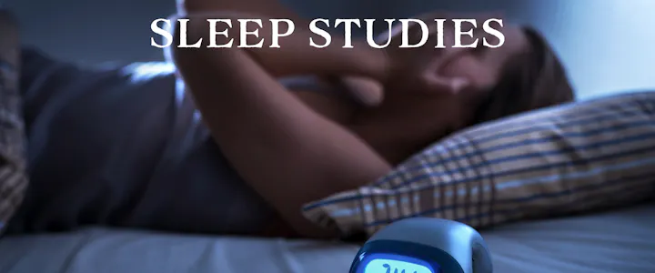 The image features someone in bed, possibly struggling with sleep, alongside a digital clock. The text reads "SLEEP STUDIES."