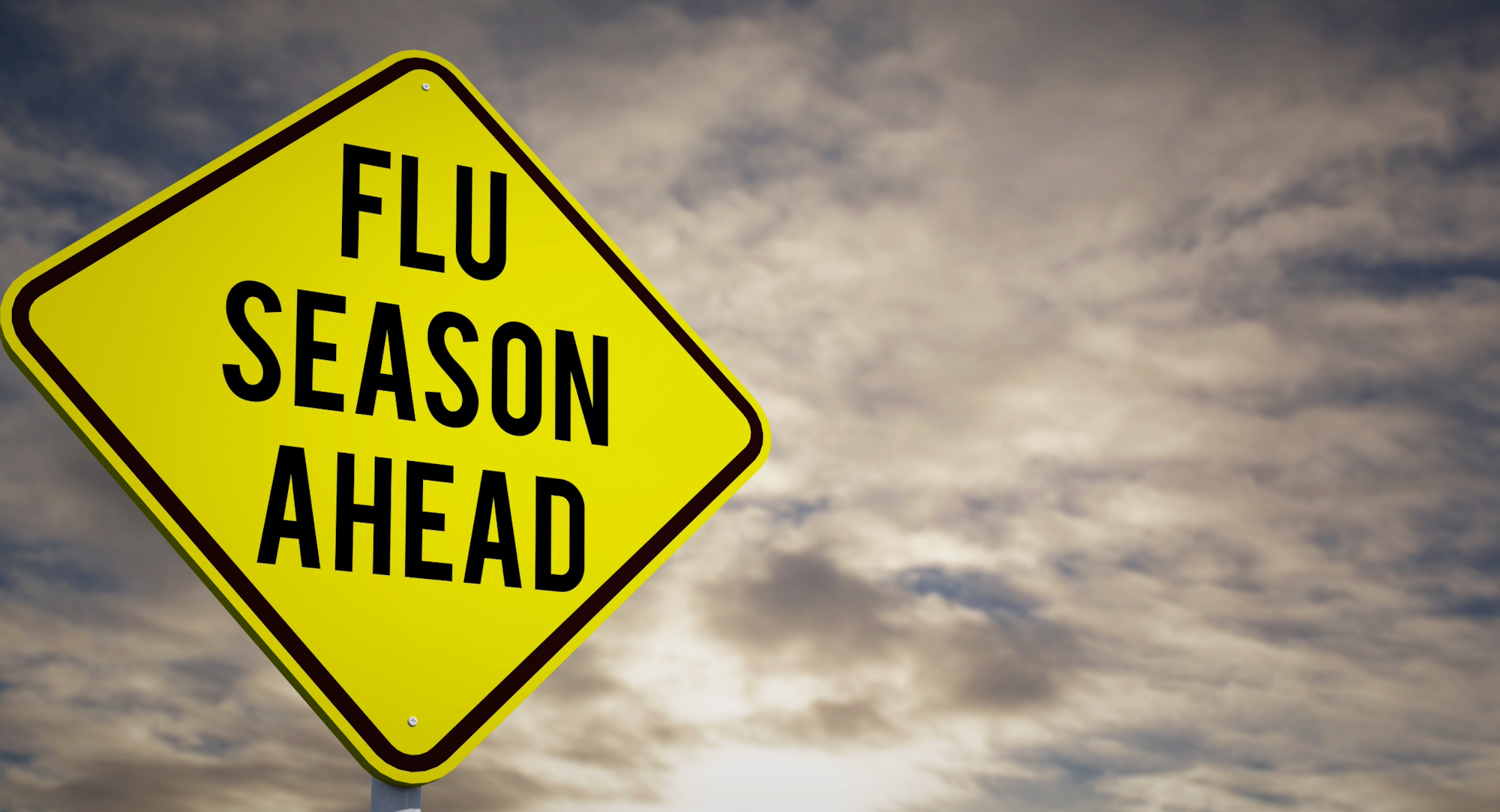 A yellow warning sign reads "FLU SEASON AHEAD," indicating the approach of flu season.