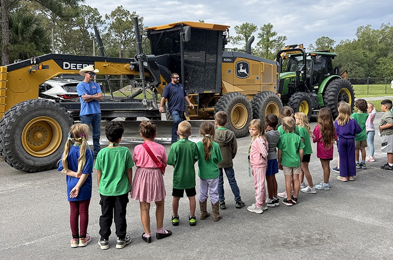 District employees Max Delle and Ryan Reeves speak to Jupiter Farms Elementary students at their Career Exploration Fair.