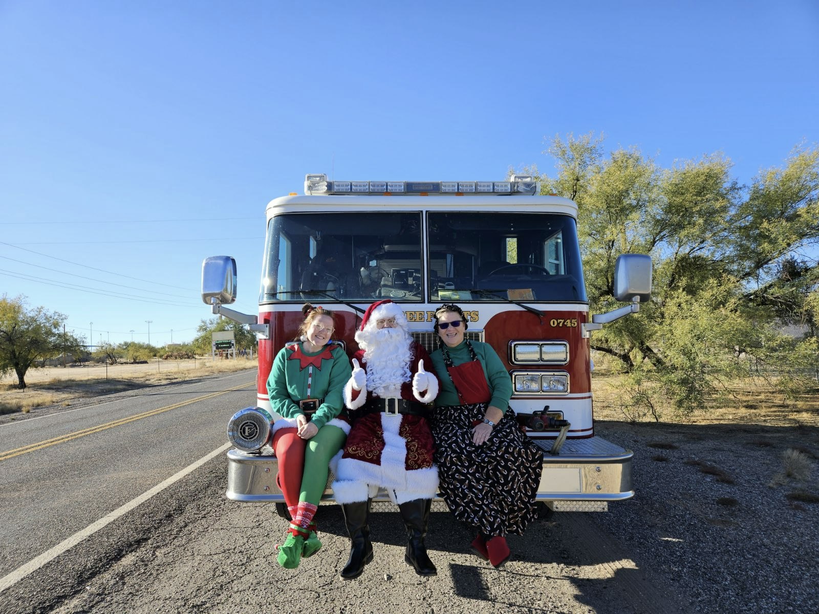 Photo of Fire truck and Santa sitting on it