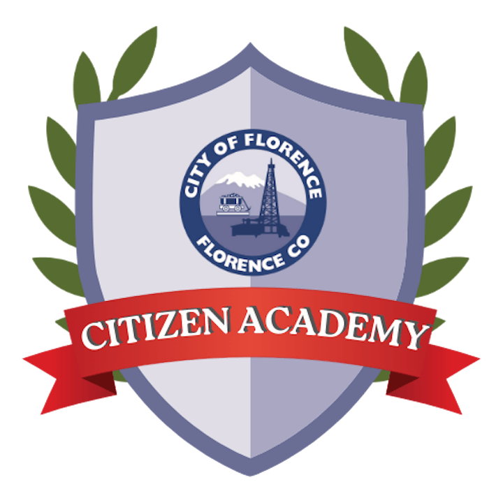Logo for the City of Florence, Colorado's Citizen Academy, featuring a shield, a banner, and elements symbolizing the community.