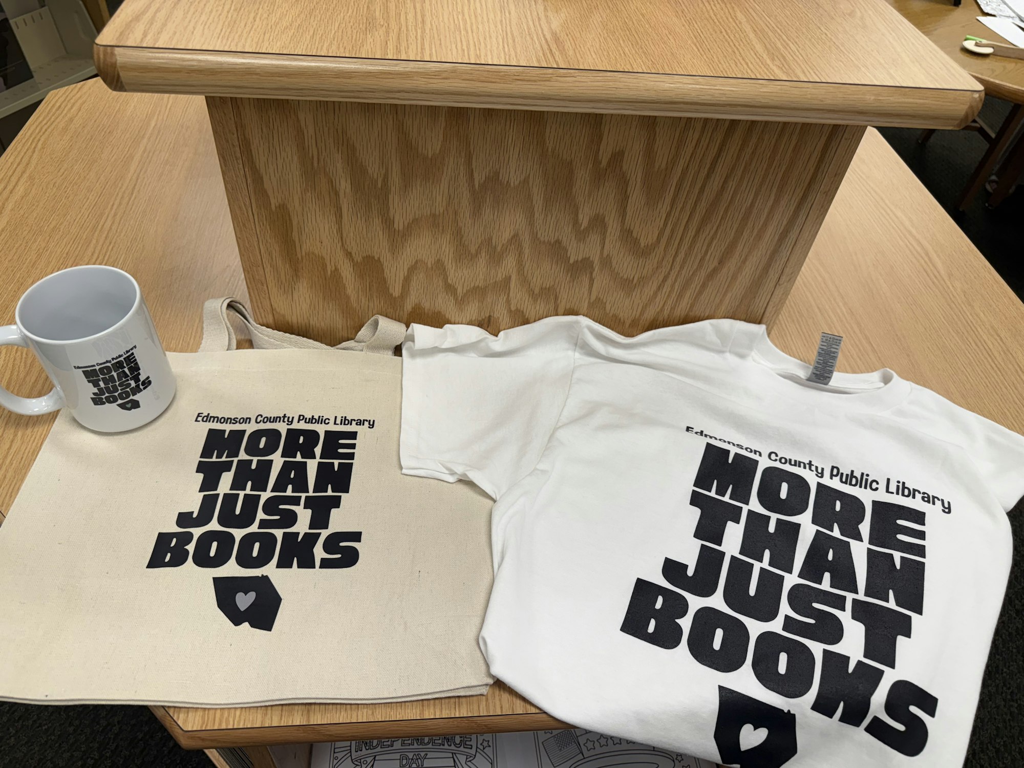 Mug, tote bag, and T-shirt with "More Than Just Books" text from Edmonson County Public Library.