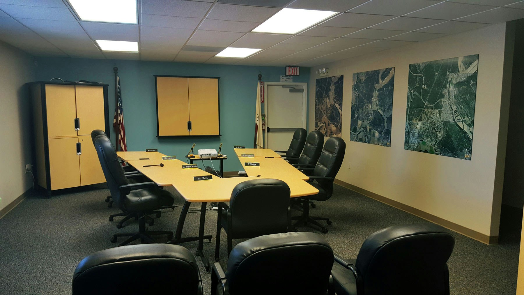 May contain: indoors, meeting room, office, room, chair, furniture, building, and architecture