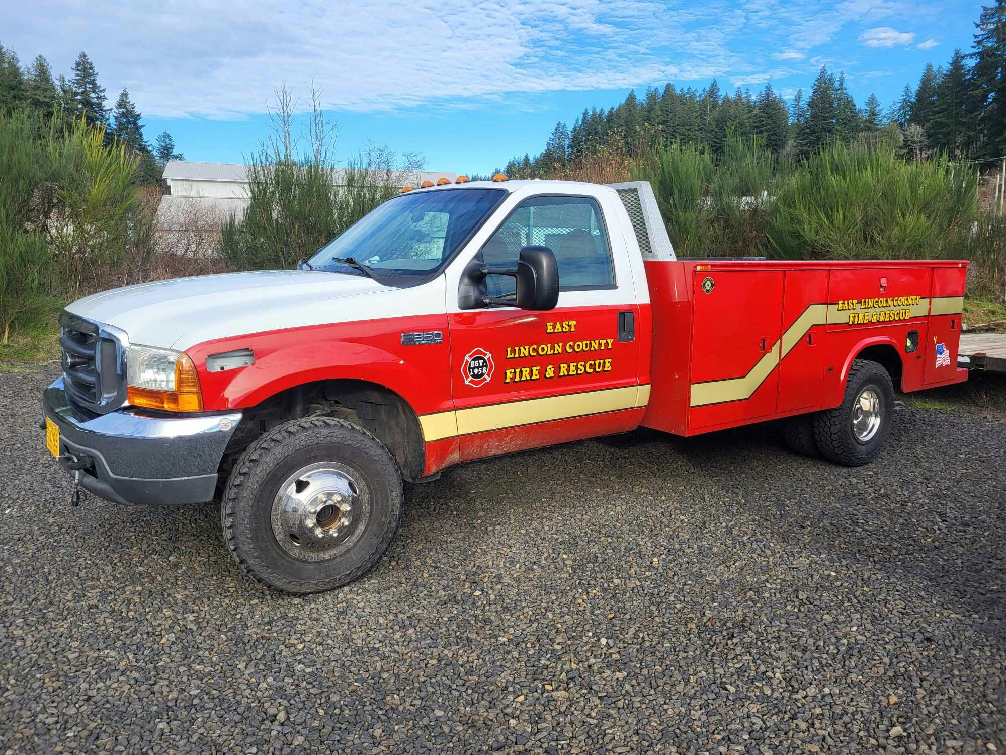 A red and white fire rescue truck labeled "East Lincoln County Fire & Rescue" parked on gravel.