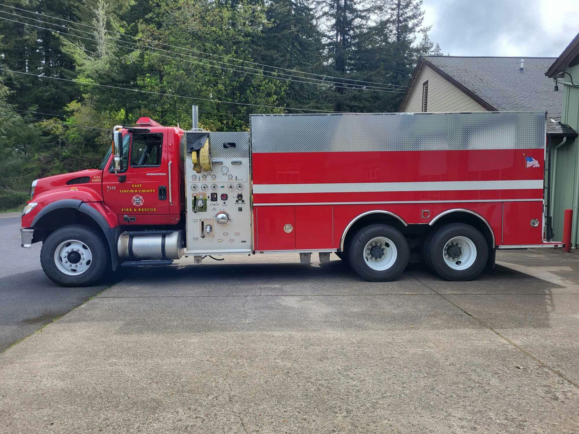 A red fire truck parked outside, labeled "East Lincoln County Fire & Rescue."
