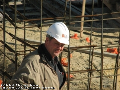 A person in a hard hat at a construction site.