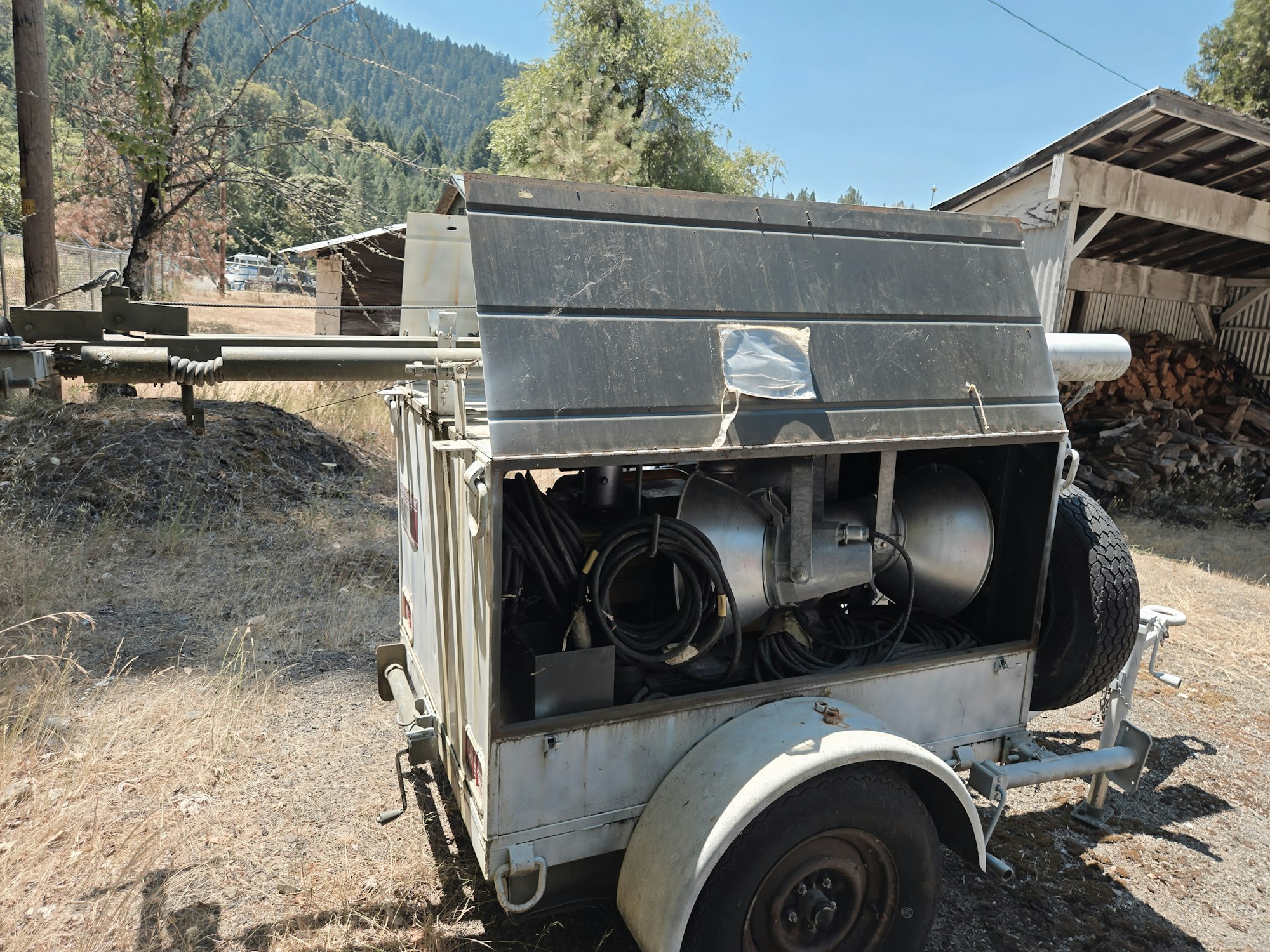 A trailer generator with open side, in an outdoor area.