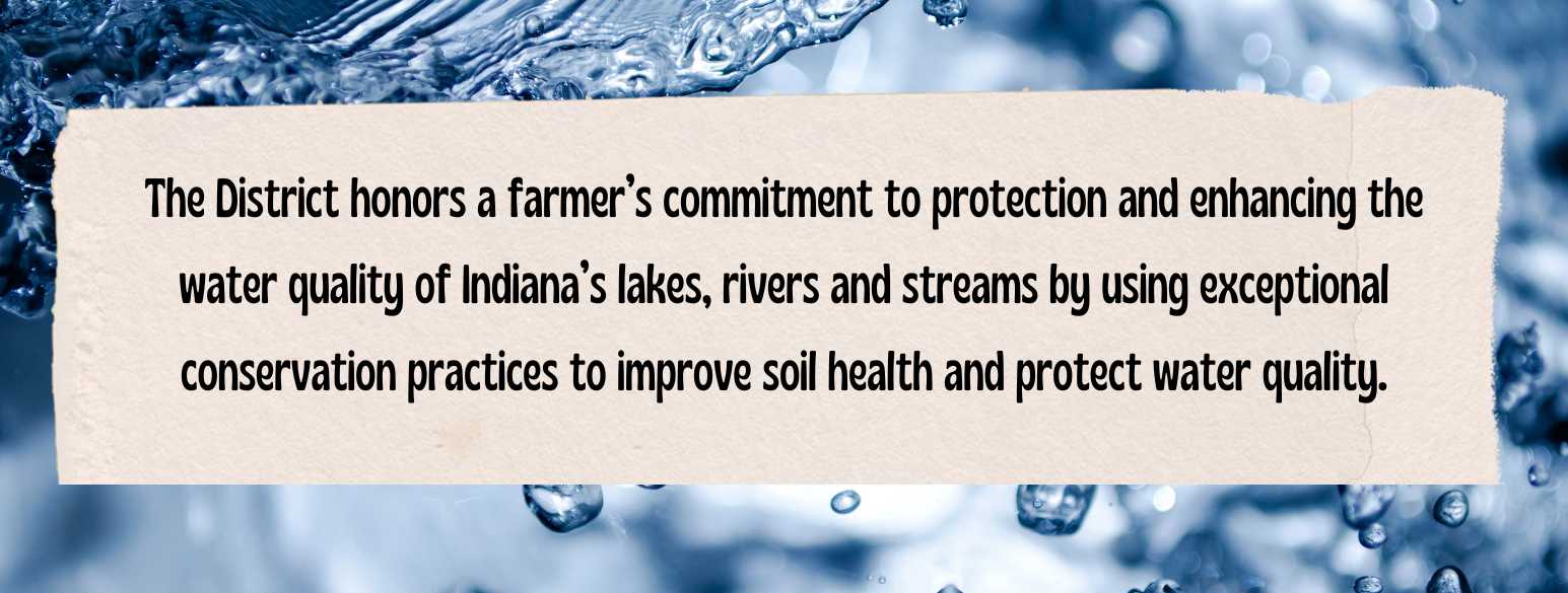 A banner honoring a farmer for enhancing water quality in Indiana through exceptional conservation practices. Text reads "The District honors a farmer's commitment to protection and enhancing the water quality of Indiana's lakes, rivers and streams by using exceptional conservation practices to improve soil health and protect water quality."