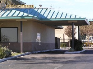 A building with a drive-thru and a teal roof. Sign: "Height Limit 10 Feet."