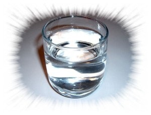 A glass of water with a white radial blur border effect.
