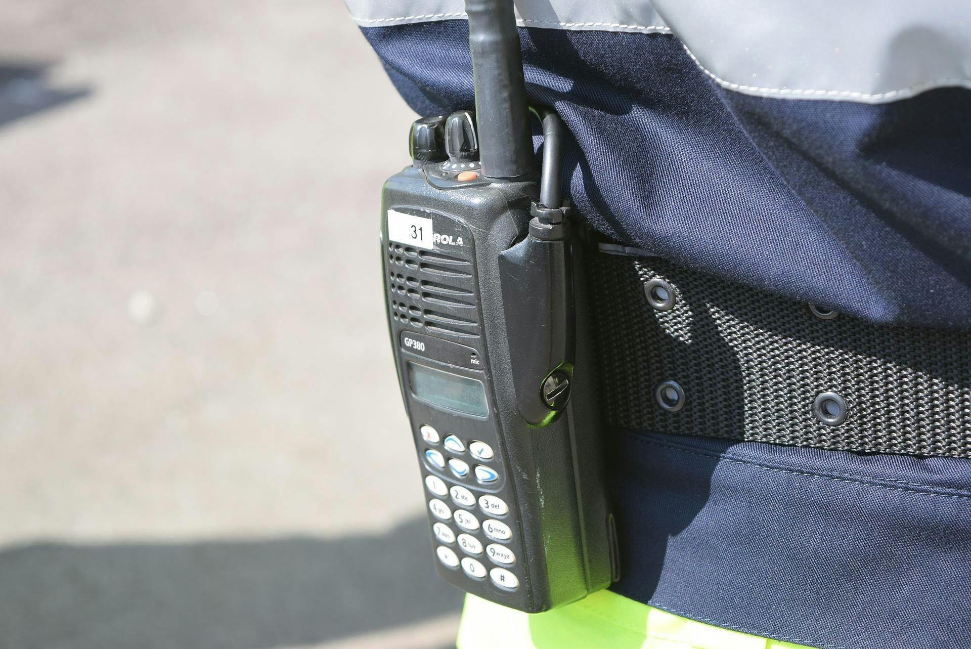 Handheld radio strapped to a waist