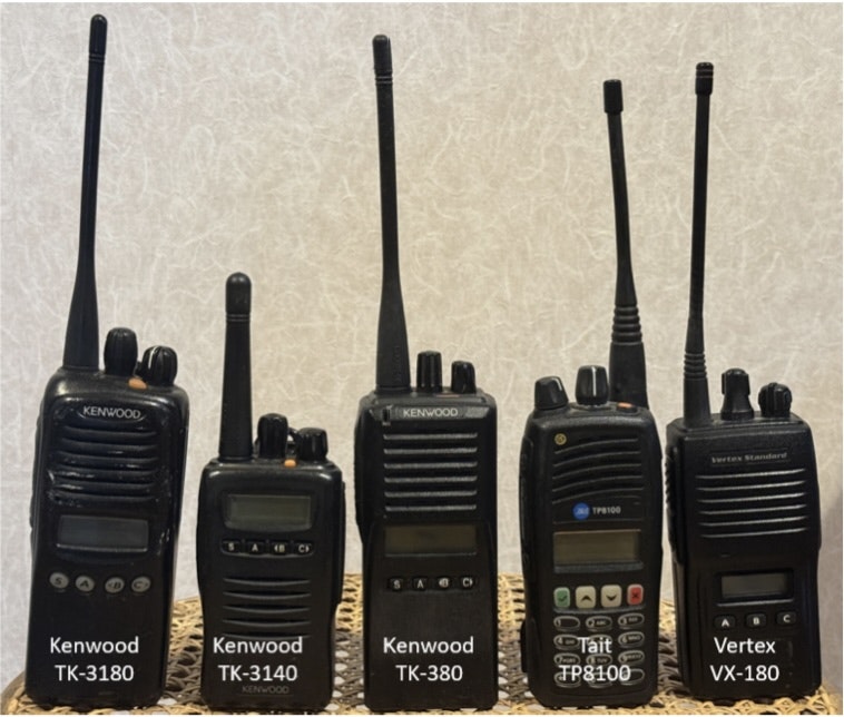 The image features five different handheld radios, including models from Kenwood and Vertex.