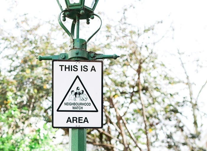 A neighbourhood watch sign on a lamppost.