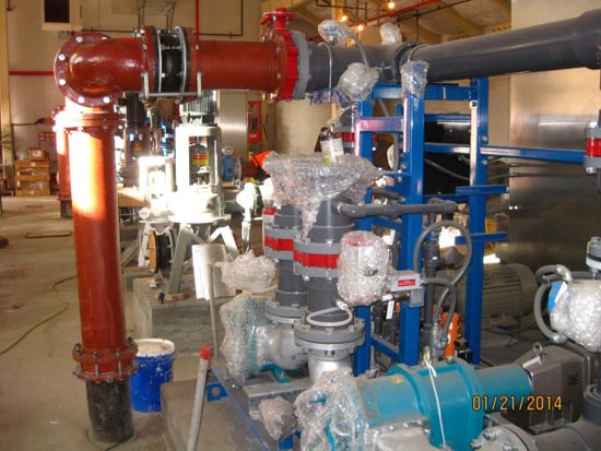 Industrial piping and machinery, with some components wrapped in bubble wrap.