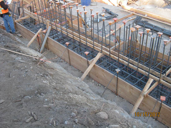 Construction site with rebar and wooden forms for concrete.