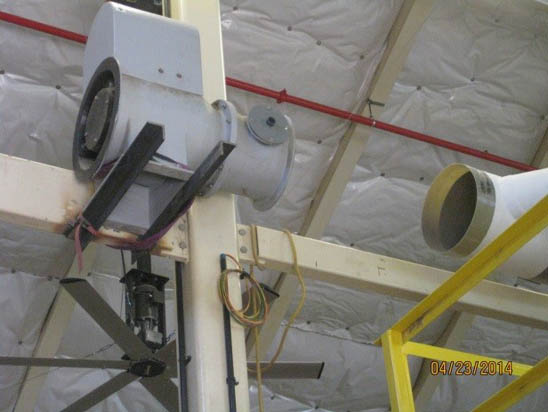 Industrial ceiling with ducts and fans, structural beams, and insulation.