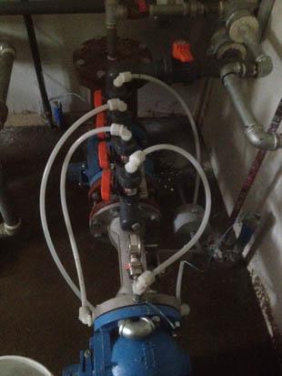A complex plumbing system with pipes, valves, and connectors, possibly part of an industrial setup.