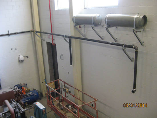 Industrial interior with ducts, pipes, and maintenance equipment. Date stamp: 03/31/2014.