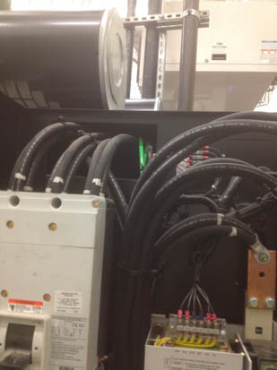 An electrical panel with cables, wires, and components.