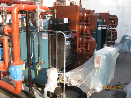 Industrial machinery with red pipes and wrapped components, dated 09/03/2013.