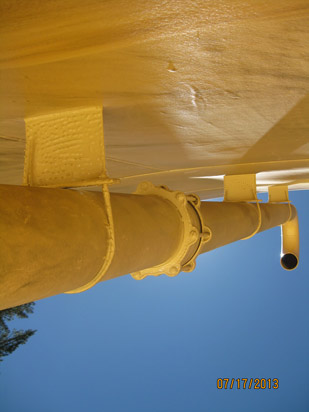 A painted metal pipe with brackets and a date stamp "07/17/2013."