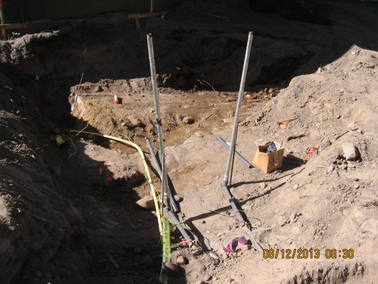 A construction site with dug earth, poles, cables, and a cardboard box. Date stamp: 08/12/2013 at 08:30.