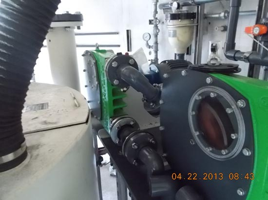 Industrial machinery with pipes, gauges, and a green component. Photo taken on 04/22/2013.