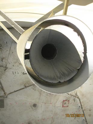 Close-up of a large pipe or vent, possibly industrial, with a circular opening. Date on image: 10/22/2013.