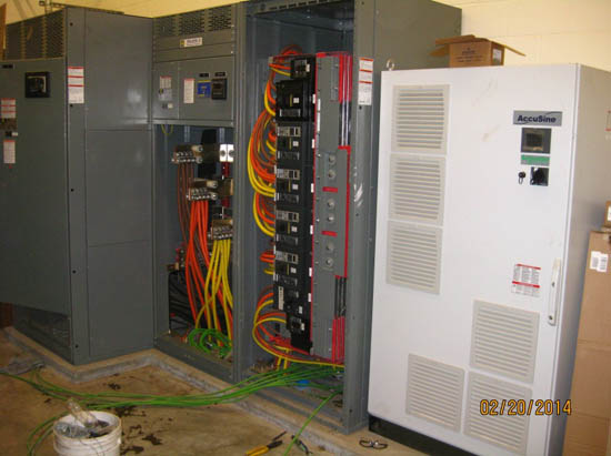 An electrical panel with colorful cables and equipment labeled "AccuSine," dated February 20, 2014.