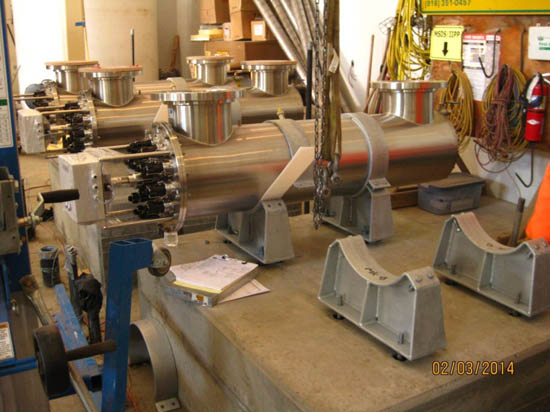 Industrial equipment with stainless steel components and cables, possibly part of a complex machinery setup.