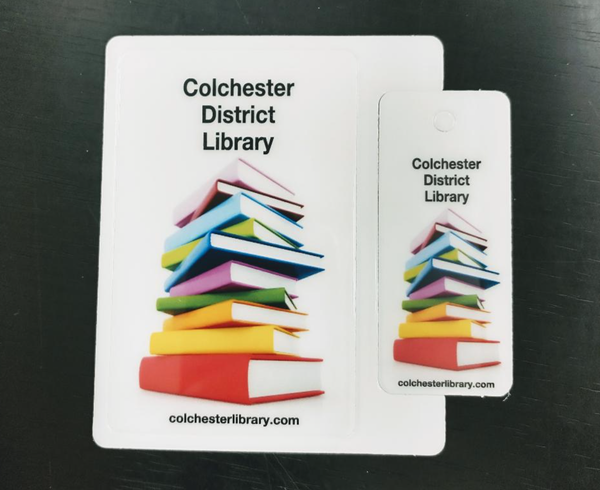 Library cards for Colchester District Library with colorful book stack design.