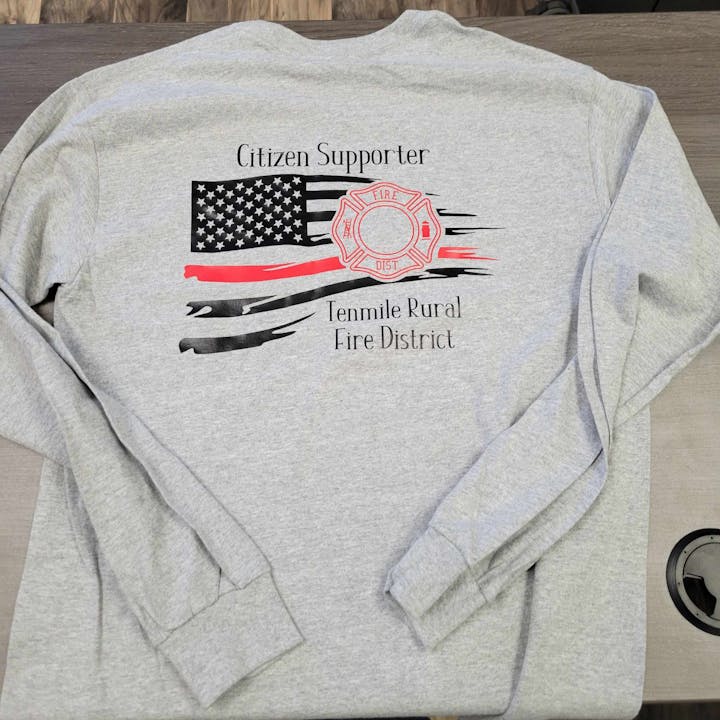 Gray sweatshirt with American flag and "Citizen Supporter - Tenmile Rural Fire District" print.