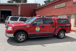 A red emergency response vehicle parked outside a building.