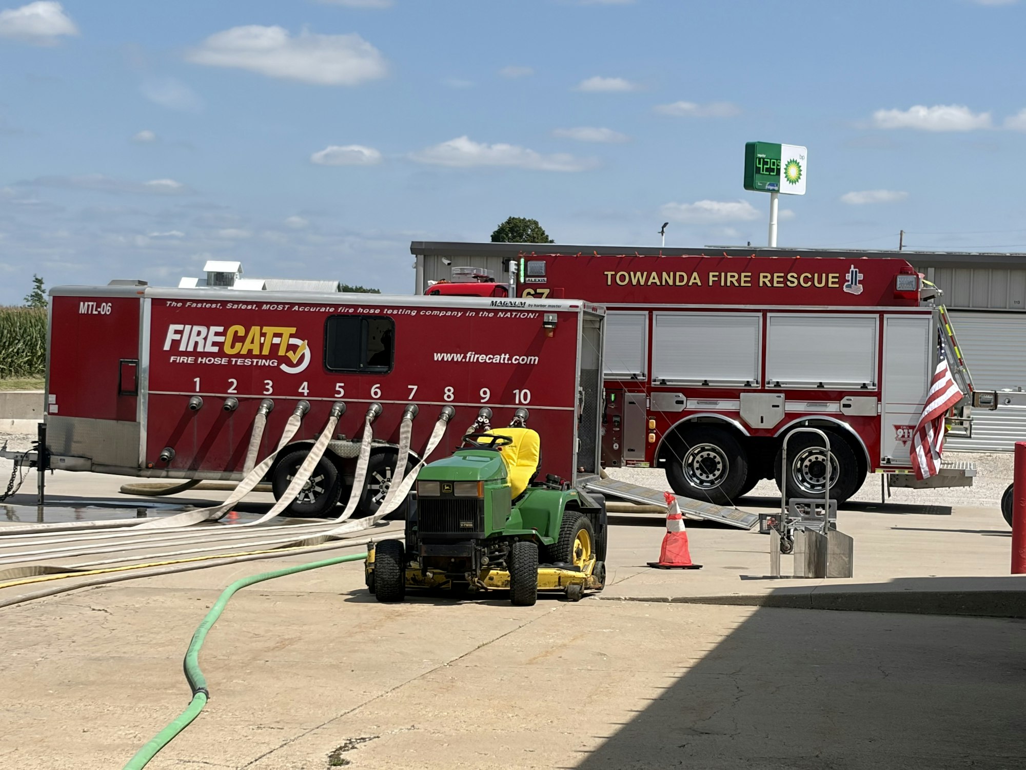 The image shows a fire hose testing unit and a fire truck labeled "Towanda Fire Rescue," with equipment and hoses visible.