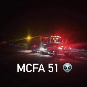 A fire truck at night with lights on, text "MCFA 51", and an alien emoji.