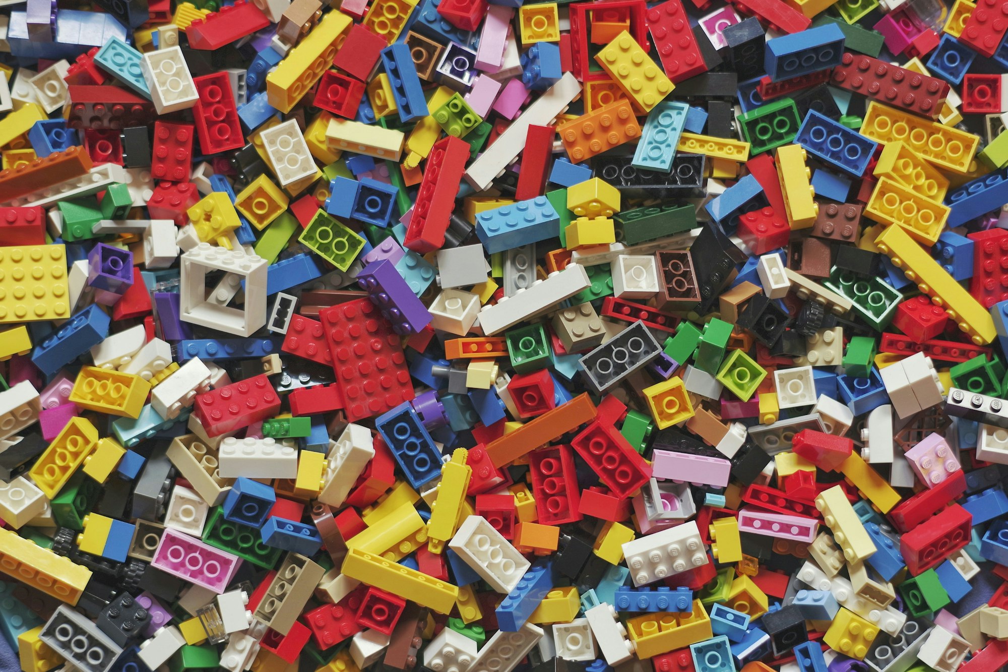 A pile of colorful LEGO bricks in various shapes and sizes.