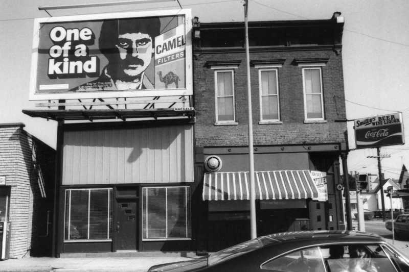 May contain: advertisement, awning, canopy, car, transportation, vehicle, light, traffic light, person, and city