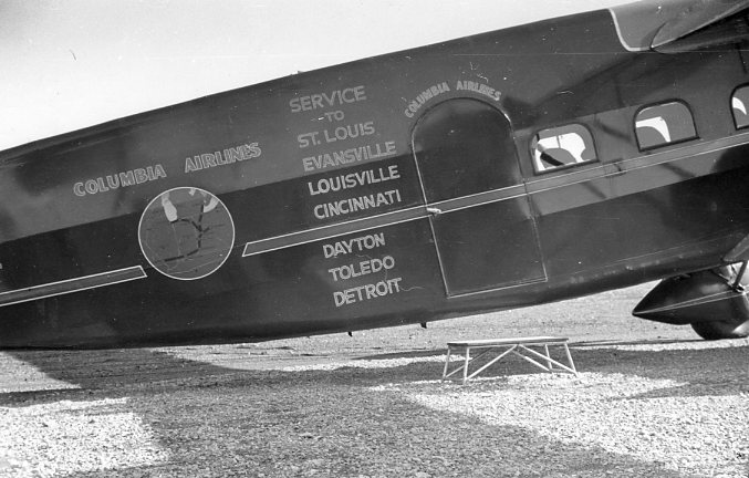 Vintage airplane from Columbia Airlines indicating service to St. Louis, Evansville, Louisville, Cincinnati, Dayton, Toledo, and Detroit.