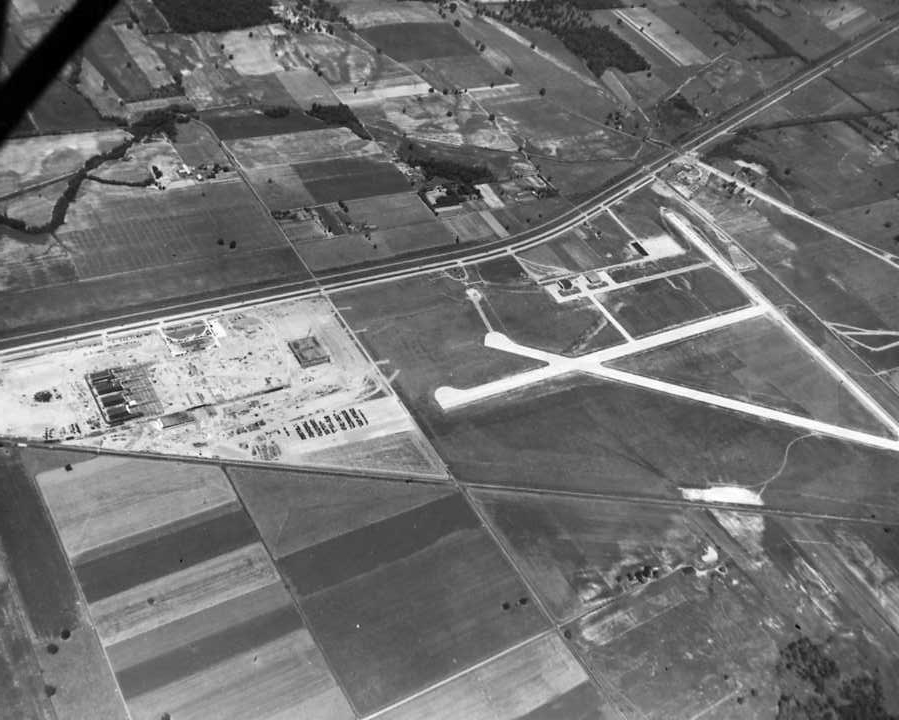 Aerial view of an airport with multiple runways and surrounding fields.