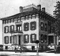 Vintage photo of an old, two-story building with a flat roof and classical architecture.
