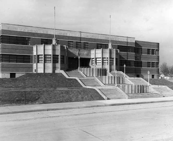Art Deco-style school building with a flight of stairs leading to the entrance.