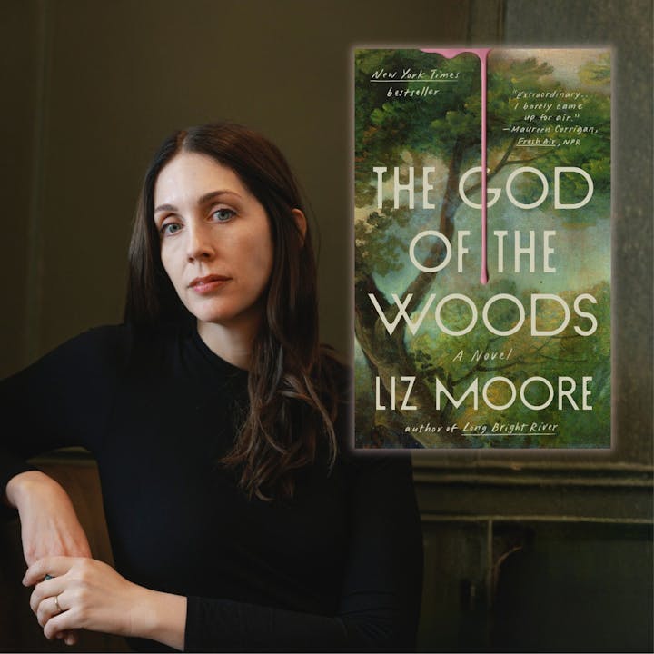 A person seated next to a book titled "The God of the Woods" by Liz Moore.