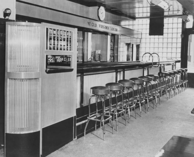Vintage bar interior with stools and a jukebox.