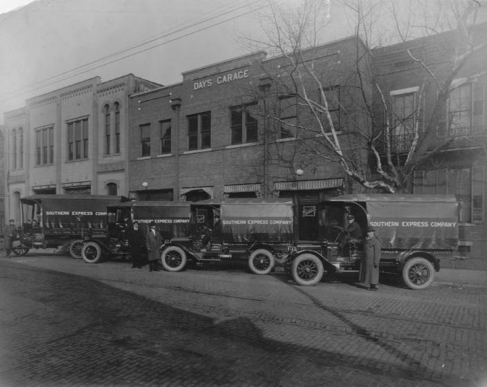Old photo of trucks from the Southern Express Company outside Day's Garage.