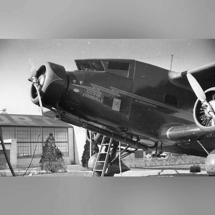 Vintage airplane on display with text "City of Evansville" and aviation symbols.