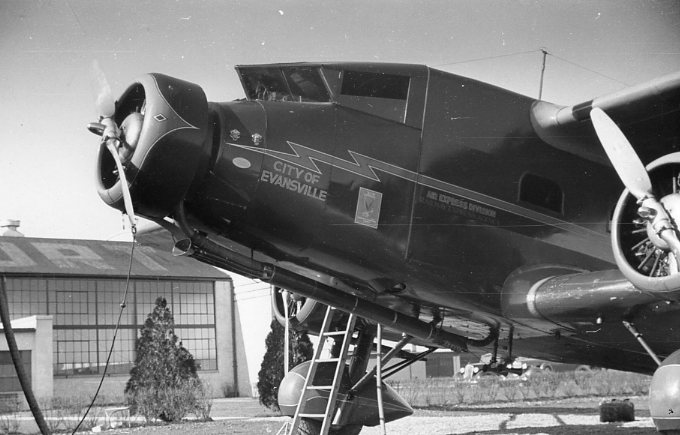 Vintage airplane on display with text "City of Evansville" and aviation symbols.