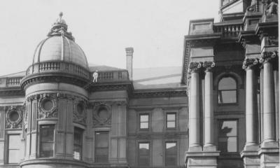 Black and white photo of a historic building with a dome and columns.