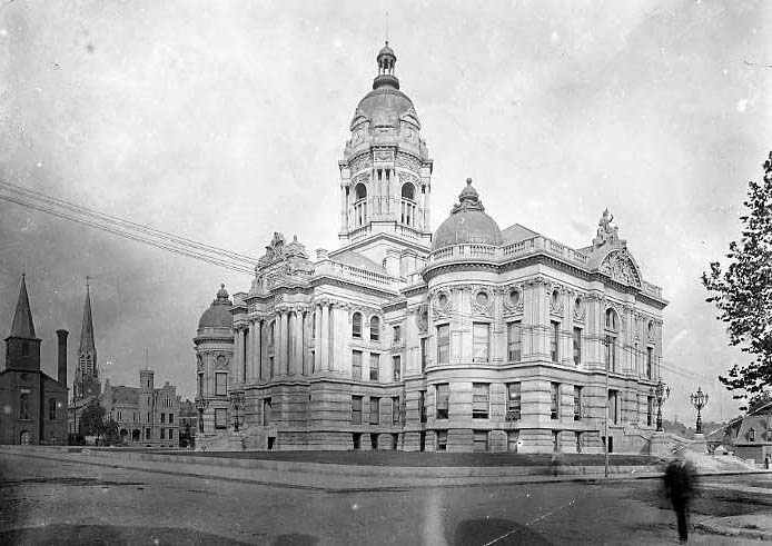 Historic building with a domed tower, likely a courthouse or capitol, in an old black-and-white photo.